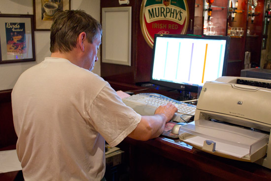 Ad Jonker types the scores into the computer