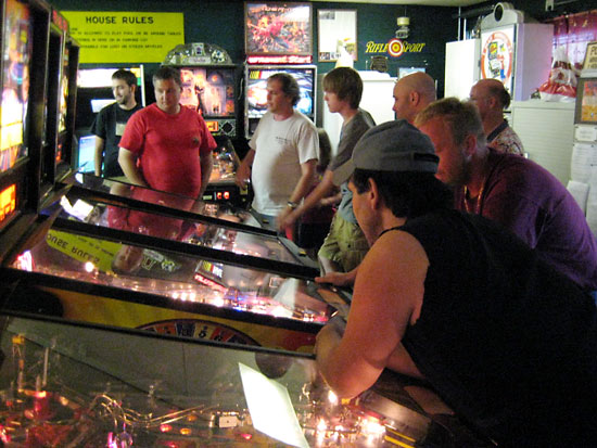 Compatriots intensely watching game play while cajoling one-another