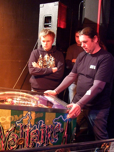 Konrad Buczynski and Pawel Nowak watch as Daniel Nowak plays Cirqus Voltaire