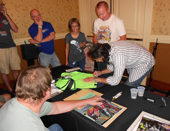 George signs items brought by the audience