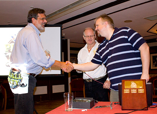 Andy presents Dennis with his induction trophy and certificate