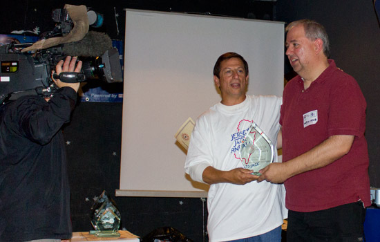 Martin Ayub accepts his trophy for the TV cameras