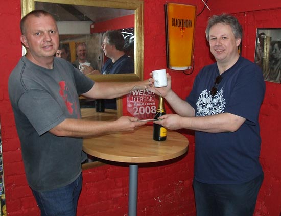 Winner Mike Parkins receives his trophy and bubbly
