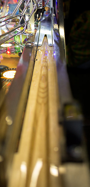 The wood of the shooter lane gives way to a metal ramp