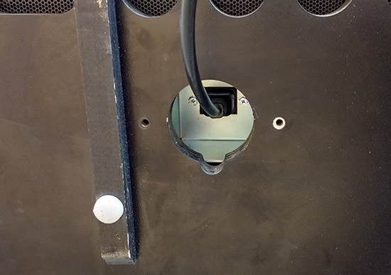 The plate covers the power connector to stop people disconnecting the cable
