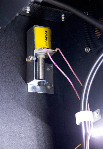 The game's knocker in the top corner of the backbox