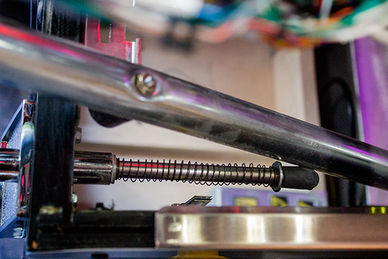 The playfield slide rail resting on the shooter rod
