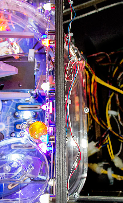 ...and travels behind the back panel...