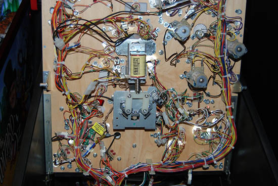 A look at the underside of the playfield, showing the mechanism to open the prison doors