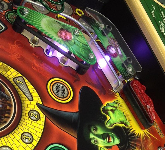 LED lighting under the inlane ball guide and inside the slingshot