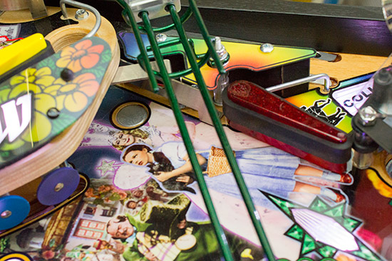 The ball drops through the hole and is grabbed by magnet above the upper flipper