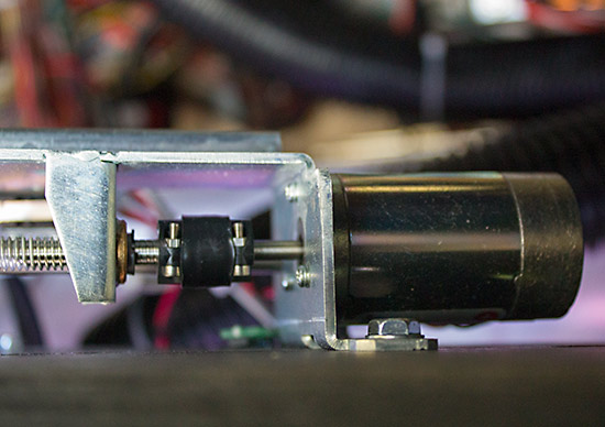 The motor turning the threaded rod