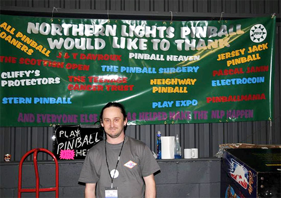 Chris with the banner at the Northern Lights Pinball