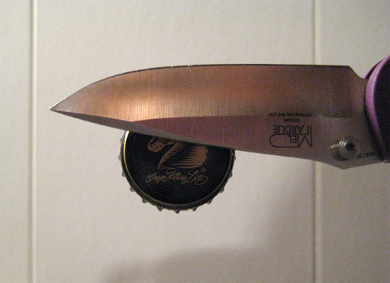The knife picks up the bottle cap