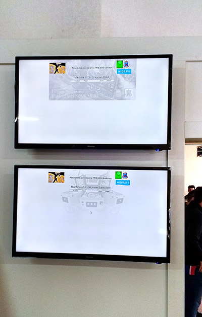 Individual machine scores were shown on monitors at the entrance to the tournament area