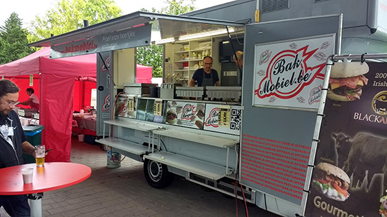 Catering trucks outside the building's entrance
