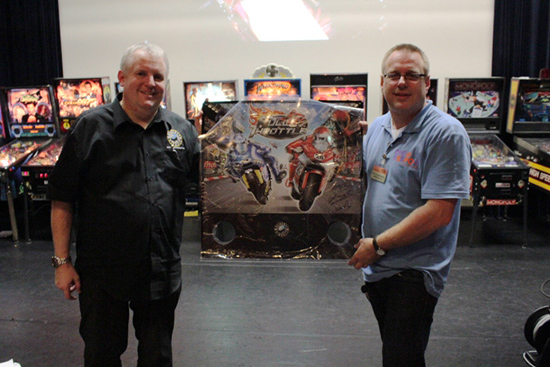 Andrew presents the signed backglass to Rens