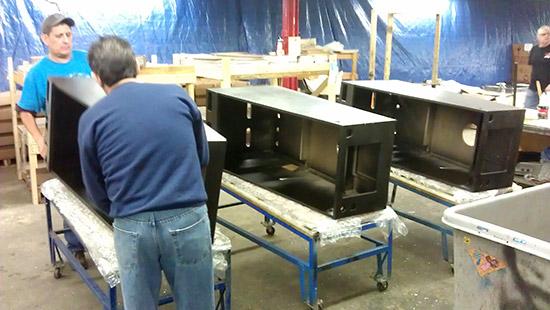 Meanwhile, cabinet preparation begins with the application of decals