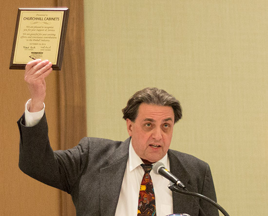 Greg Kmiec presents the award to Churchill Cabinets