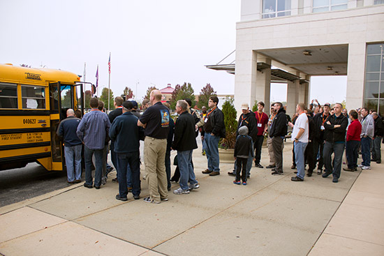 Show visitors board the first of the school buses