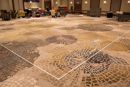 Tape on the carpet defines each vendor's space