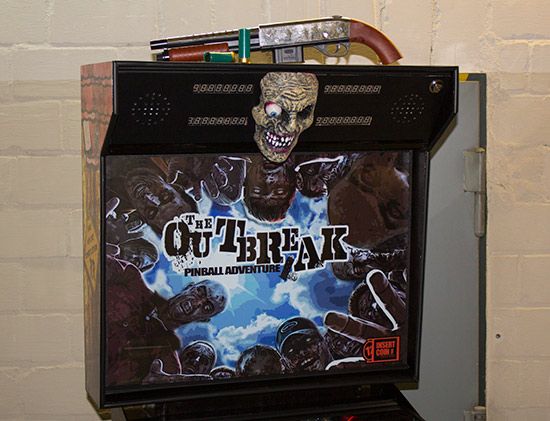 The zombie head mounted on the backbox between the score displays