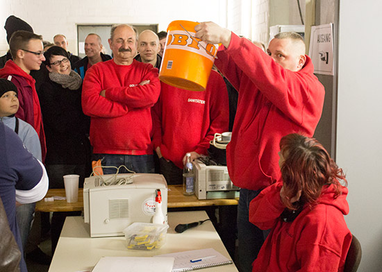 The bucket containing the raffle tickets is given a stir