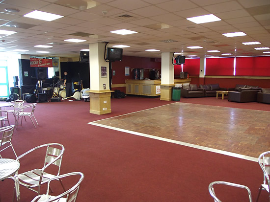 The band sets up in front of the dance floor