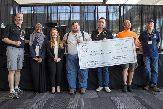 Rawuda collects her $5,000 scholarship cheque