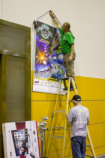 The first of several posters is hung on the wall