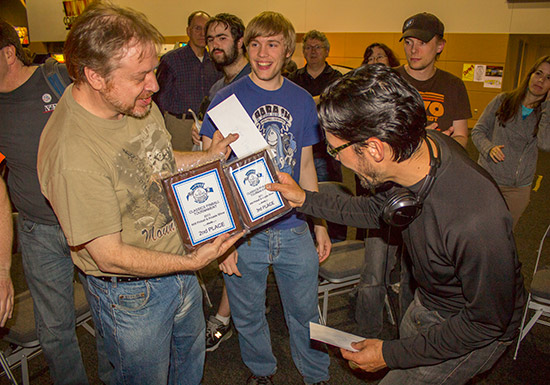 The two John's compare their second and third place plaques
