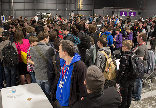 Magic: The Gathering players check out the next round draw