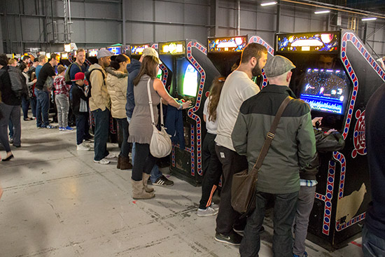 The video games were located next to the pinballs