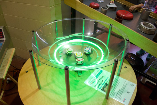This flashy and noisy exhibit shows how pop bumpers can transfer energy into the balls in the clear bowlto create seemingly random motion
