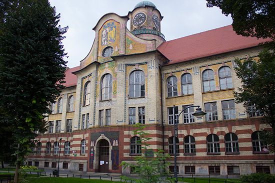 One of the schools, topped off with the city's coat of arms in mosaic