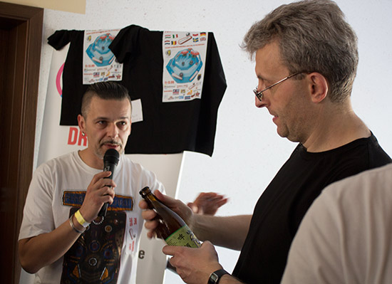 Łukasz presents Marcin with a special drink