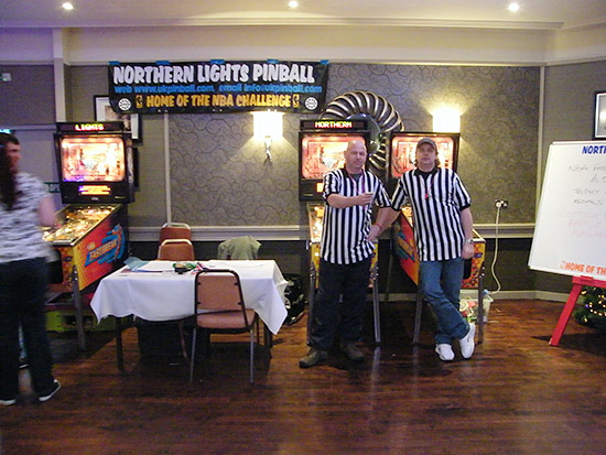 Referees Mark Robinson and Darren Ball poised to toss the coin