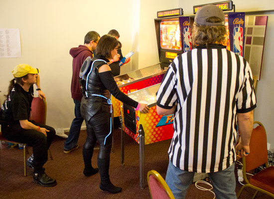 Kate Morris plays NBA Fastbreak in her Tron outfit, complete with blue LE wire