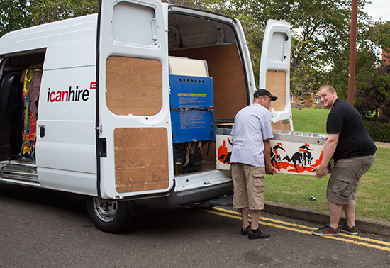 Stan Simson and Matt Vince unload one of the many vans packed with games