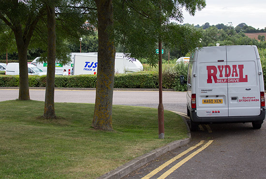 Soon, the car park is filled with a multitude of white vans
