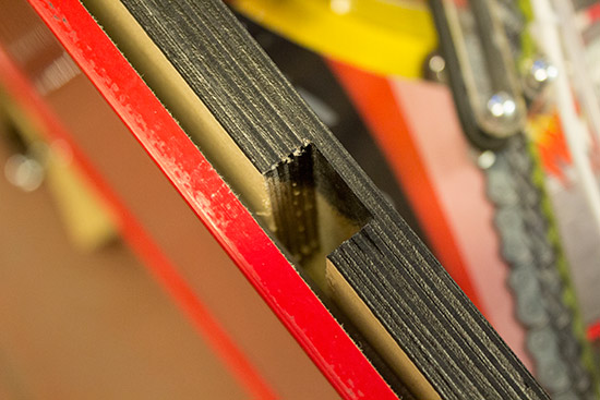 The slot between the outer panels and the inner carcass where the side artwork drops in