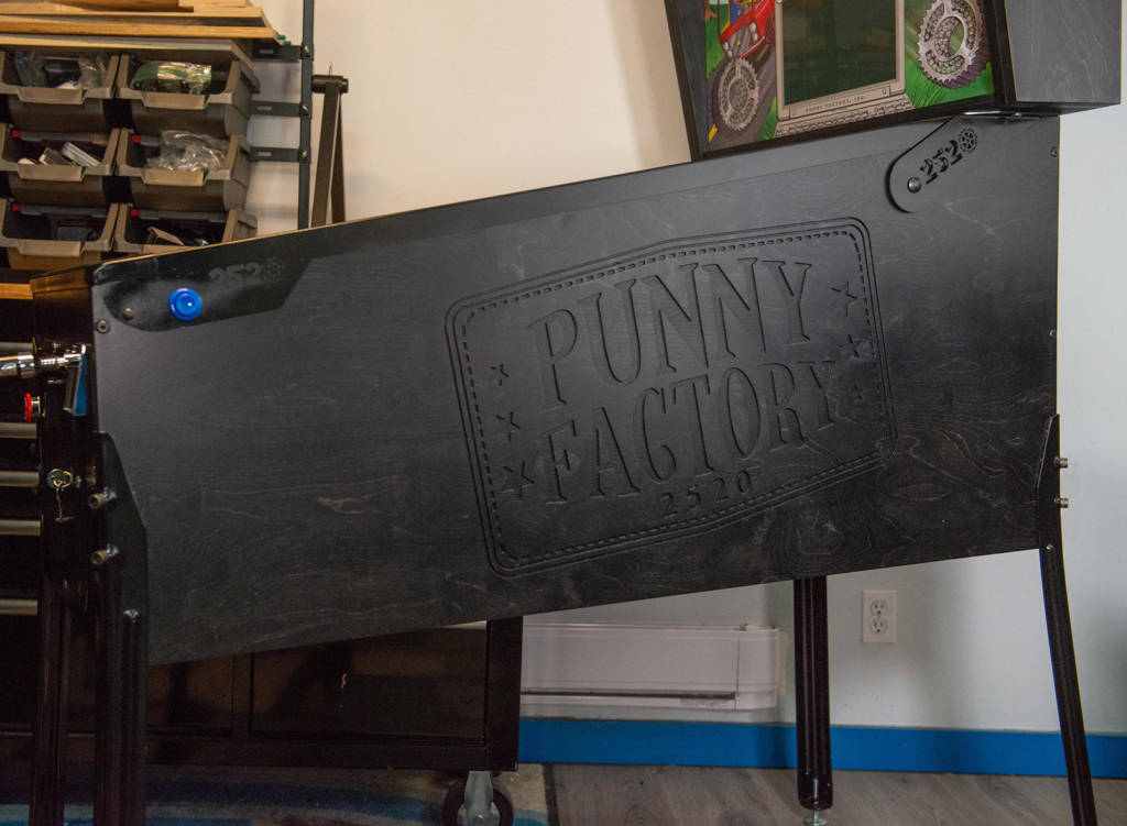 Stained wood with the Punny Factory logo engraved on the sides