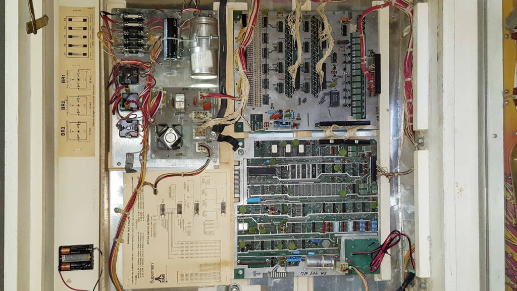 Superman (Atari 1979) photo inside the backbox. Like other manufacturers were doing with their solid-state pinball designs, this Generation 2 game saw Atari move the circuit board components into the backbox rather than keep them in the bottom of the cabinet. Photo by author.
