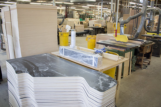 Stacks of cut video game cabinet sides and pinball bottom panels