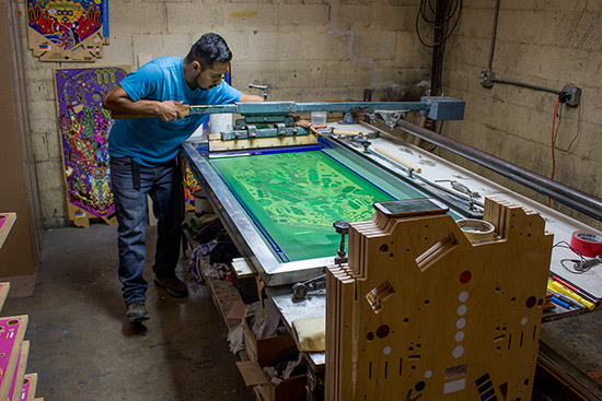 The ink squeegee is slid down the playfield