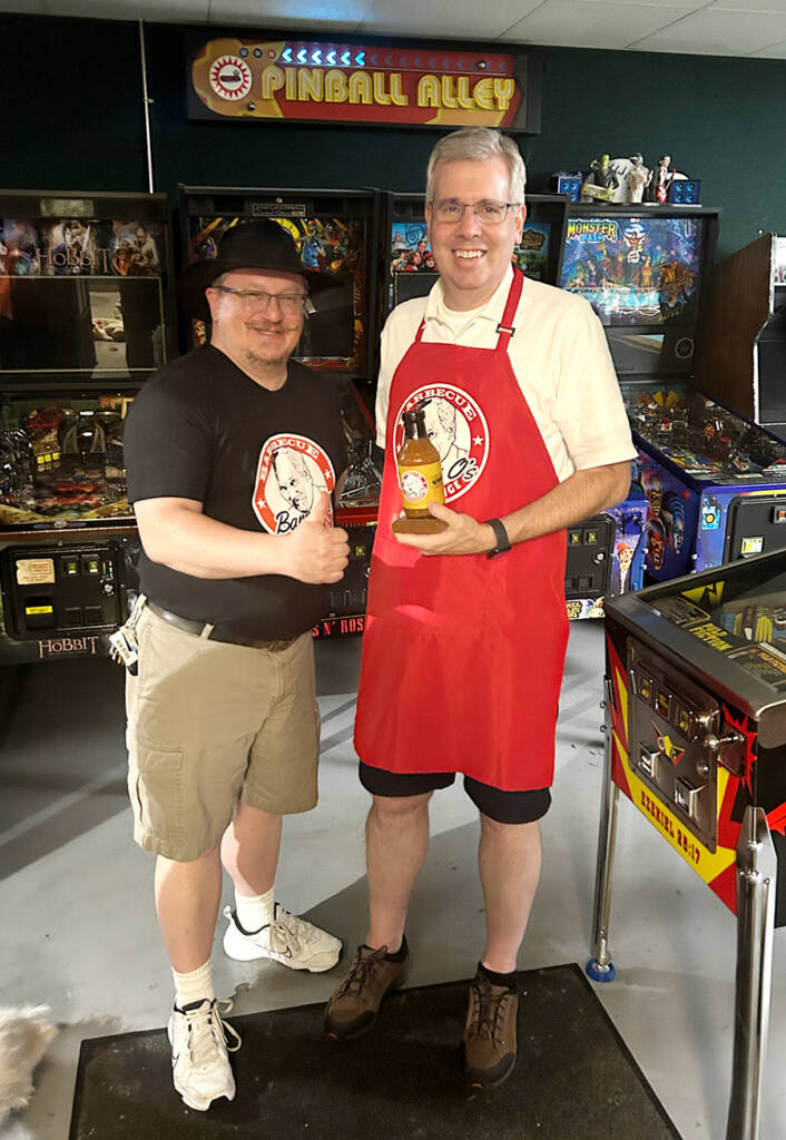 High Score Competition winner, John, receives his prize from David Fix