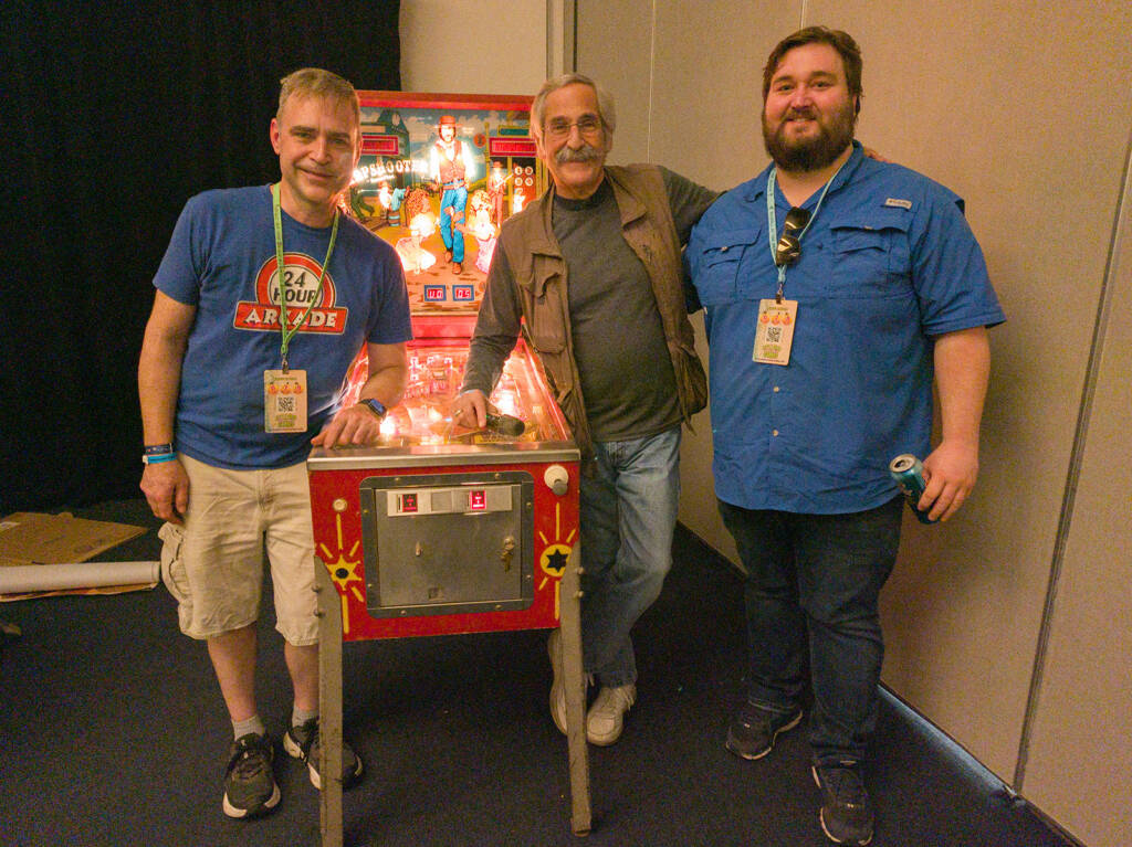 Pinball at the Beach organiser, Marshall,with Roger and the owner of the Sharpshooter machine, Tucker