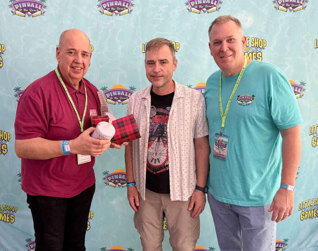 Pinball News Editor, Martin Ayub, presents the gifts to Marshall and Ed