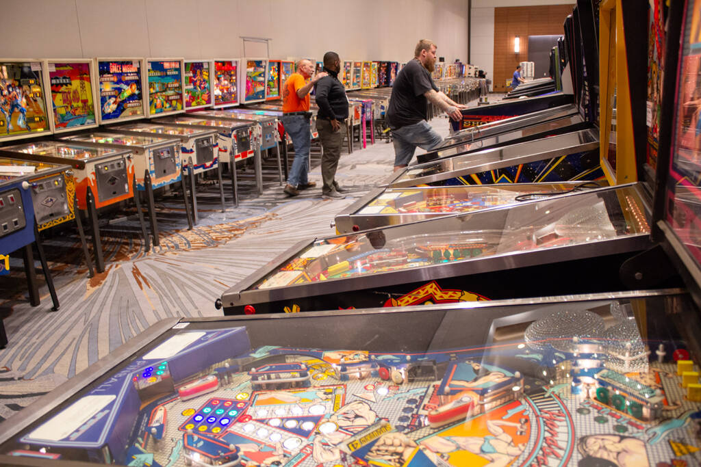 Machines are arranged in long rows running the length of the room