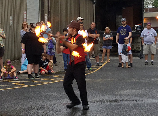 After the outdoor flea market closed, fire juggler Eric Girardi stoked the crowd